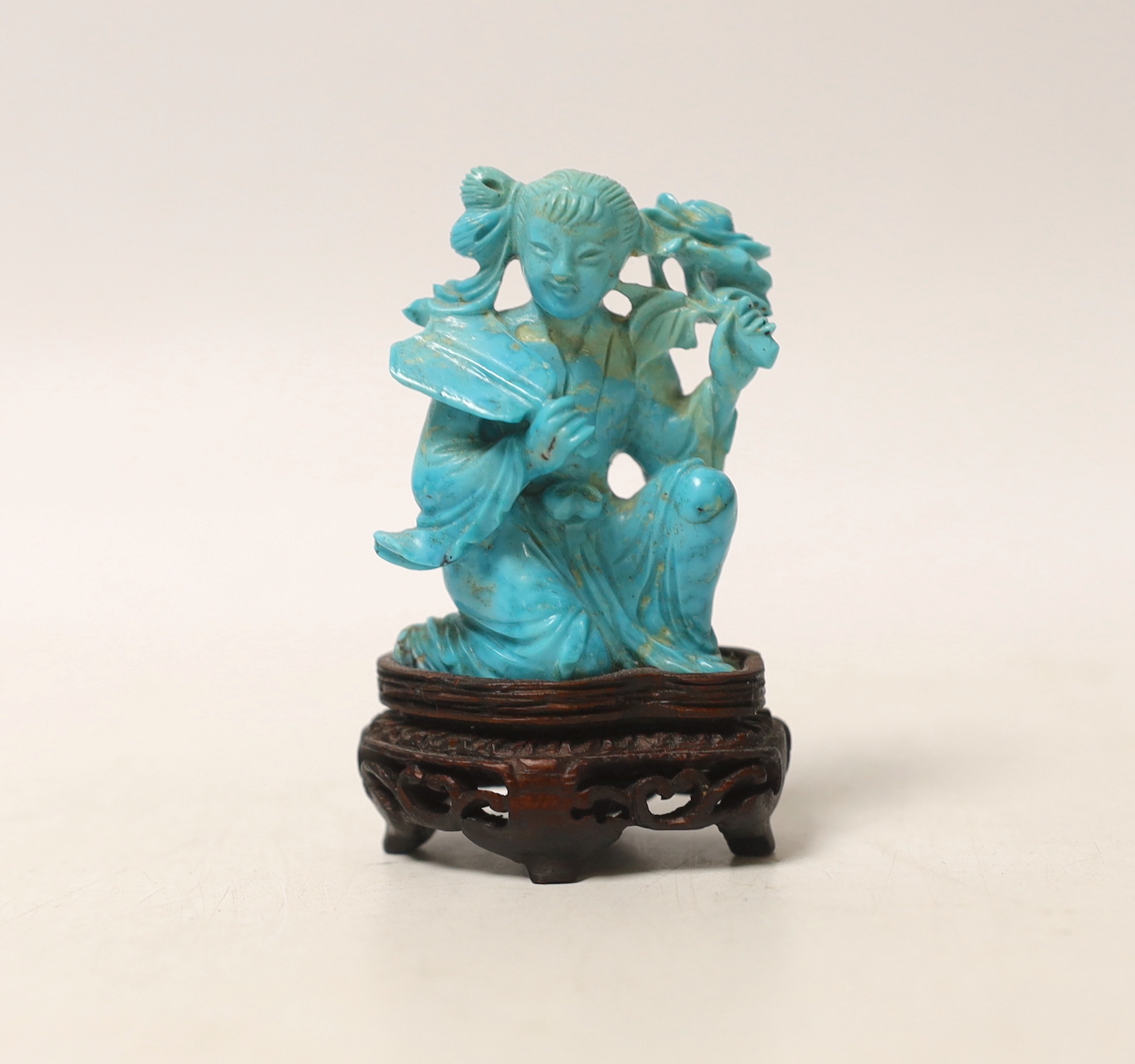 An early 20th century Chinese carved turquoise figure of a lady, on wooden base, 6.5cm high